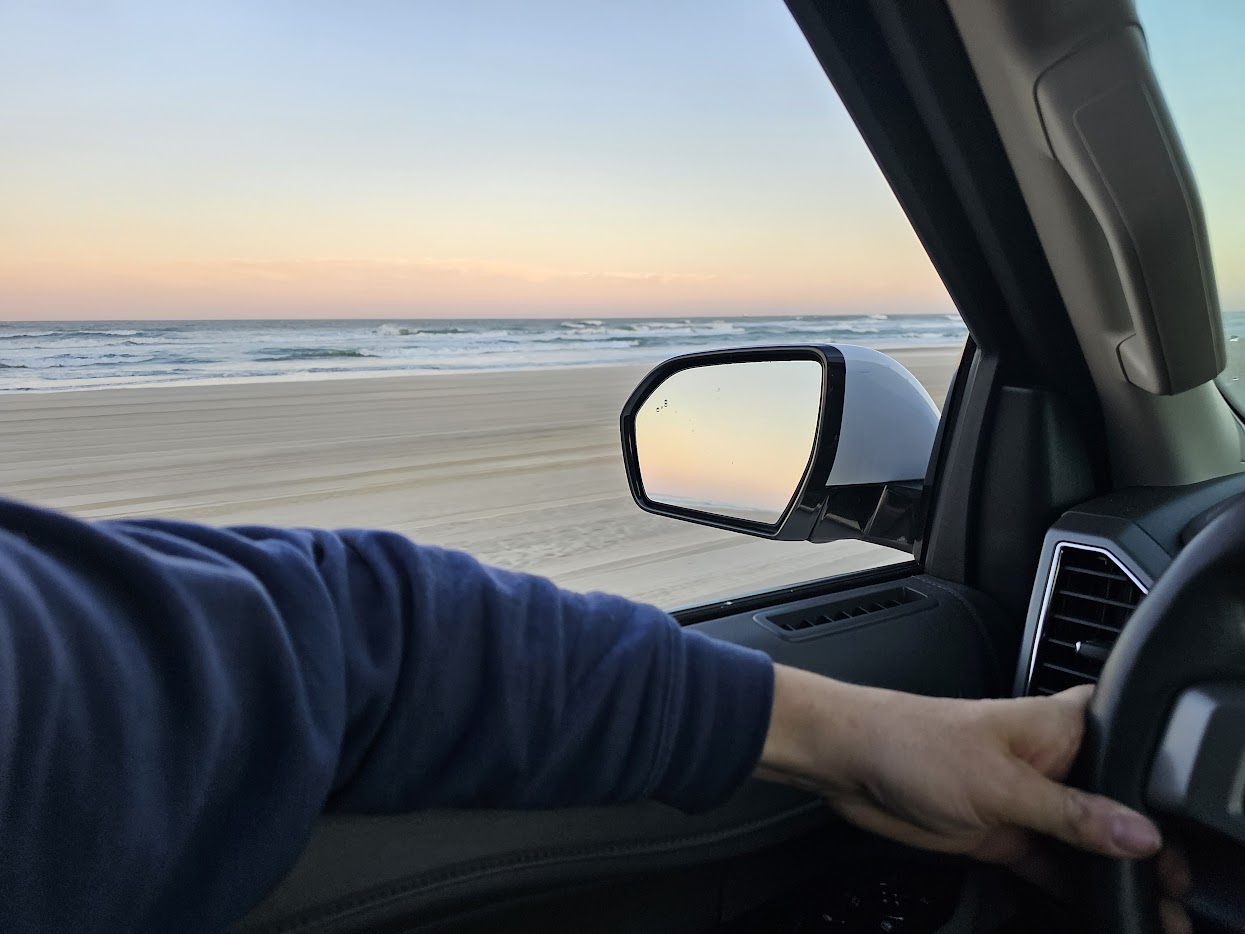 Driving on Carova beach at sunset